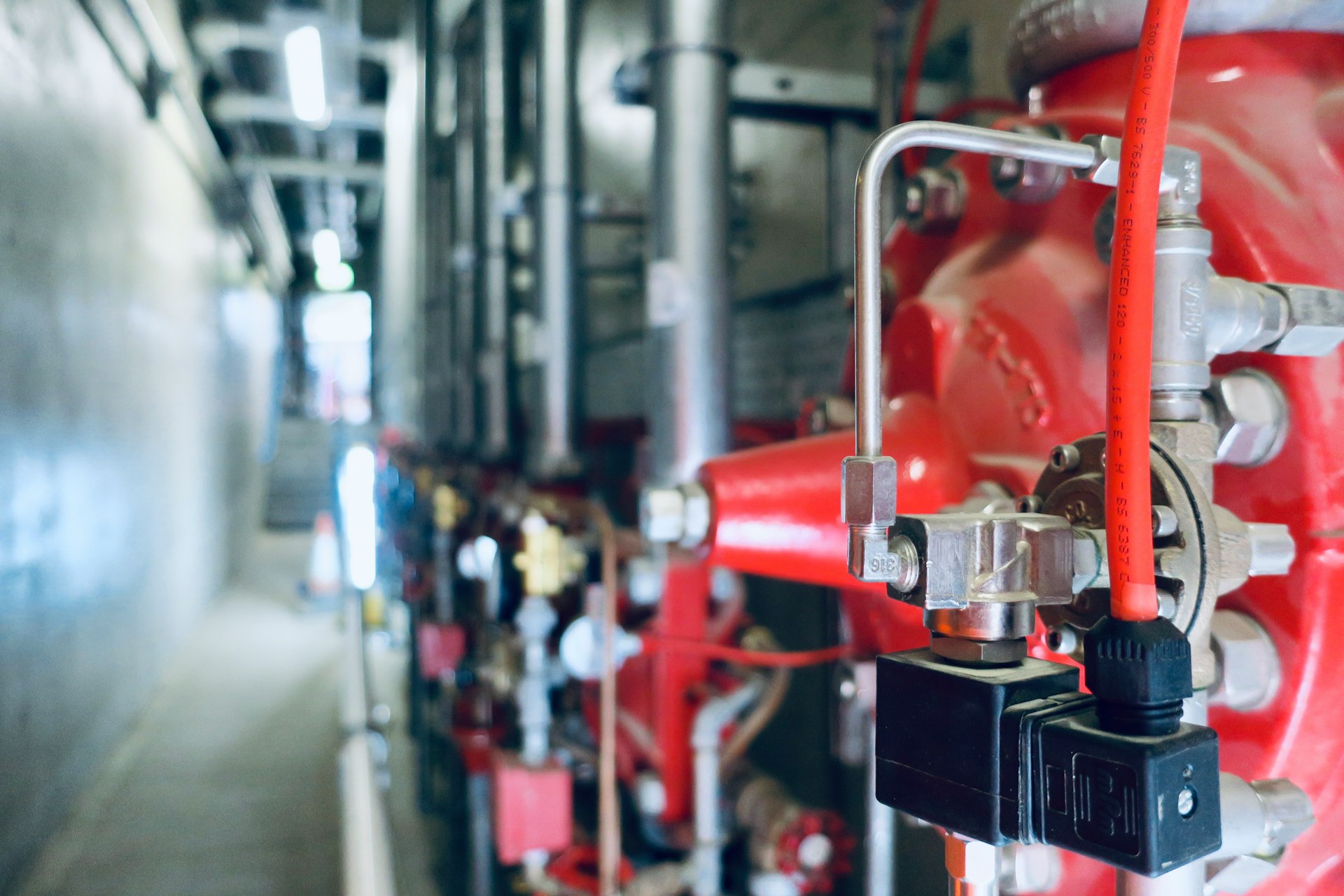 a close up of pipes and valves in a building